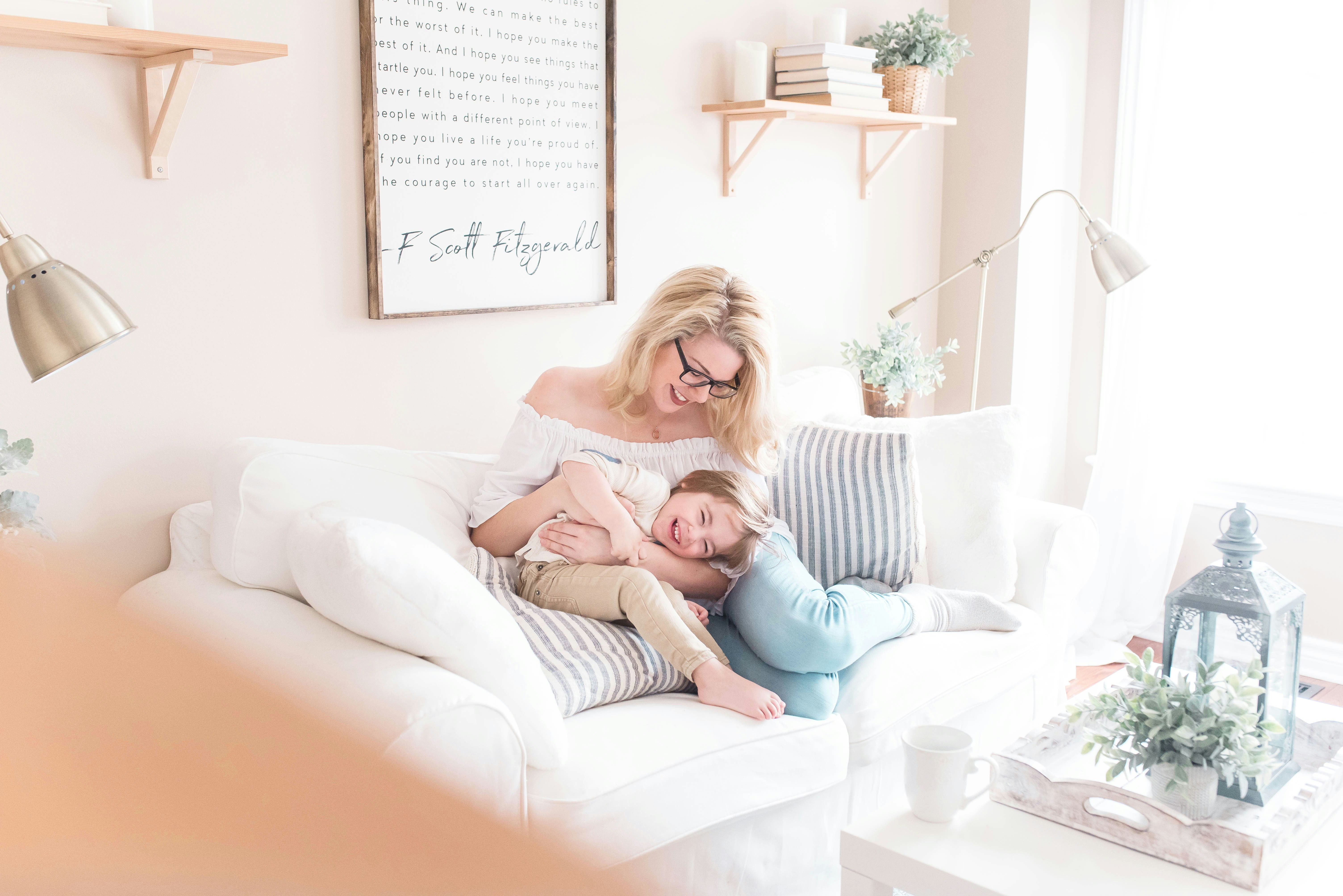 A mother on the sofa with her two children at home